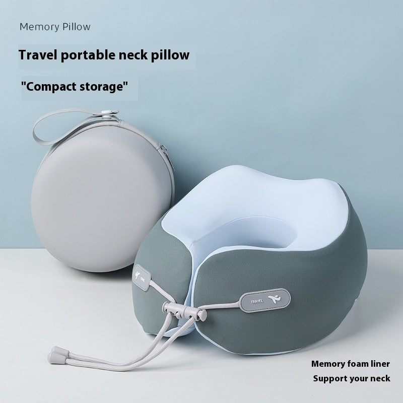 Green travel neck pillow with front drawstring beside a white zippered carry case