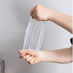Hands stretching a silicone lid to show how far it stretches
