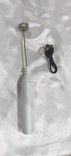 White milk frother with its charging cable