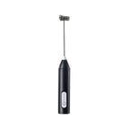 Black handheld milk frother with its metal whisk attached, on a white background.