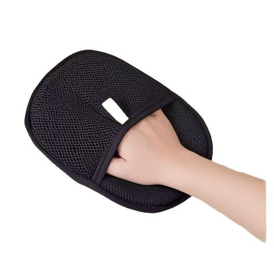 Hand inside the black mesh pocket of the pet hair removal mitt