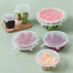 Six clear silicone stretch lids covering bowls, jars and a cut watermelon