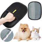 Black pet hair removal mitt with hand pocket, its gray fabric side, a dog and a cat