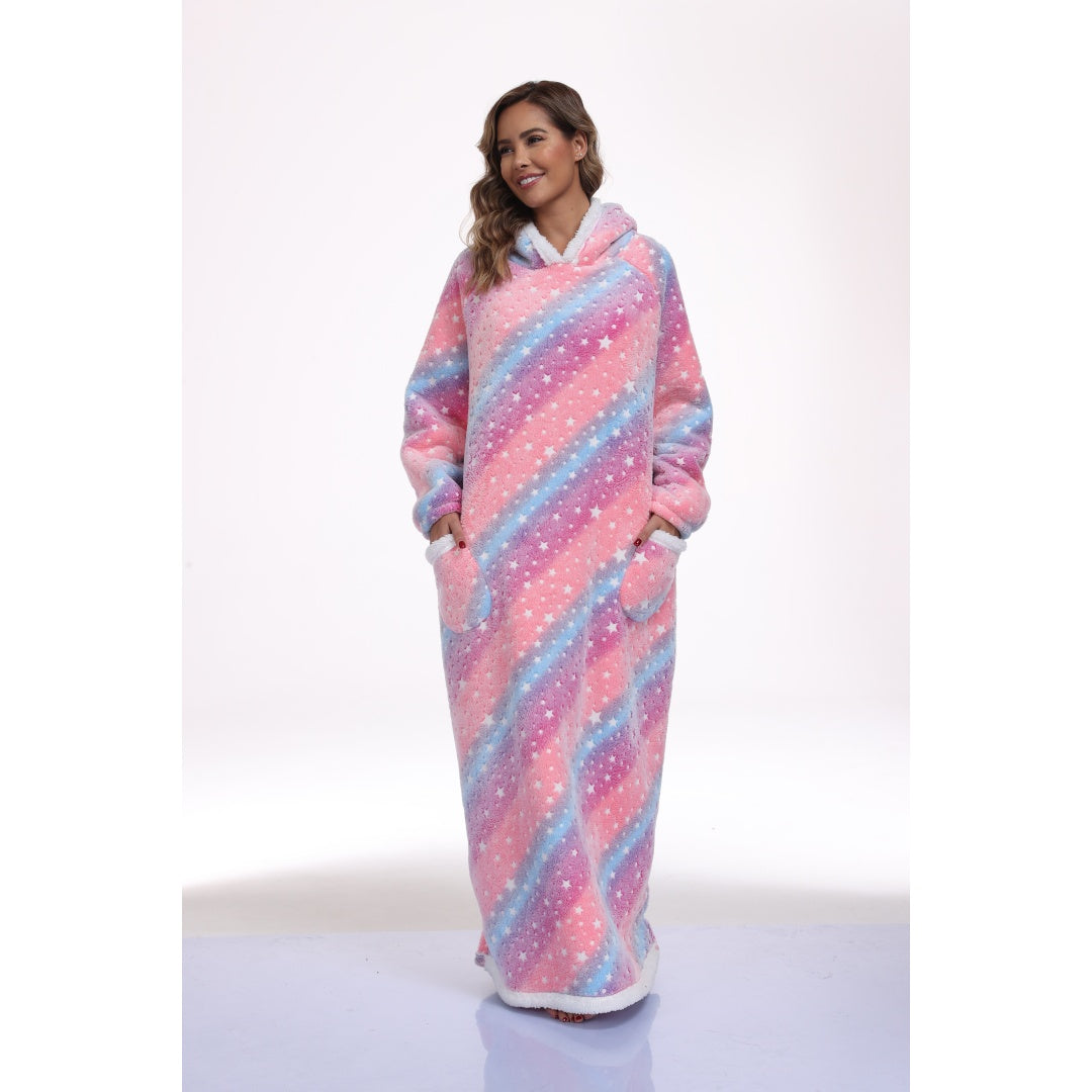 Model wearing a long pink and blue star-print hooded blanket with front pockets