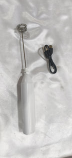 White milk frother with its charging cable, from another angle